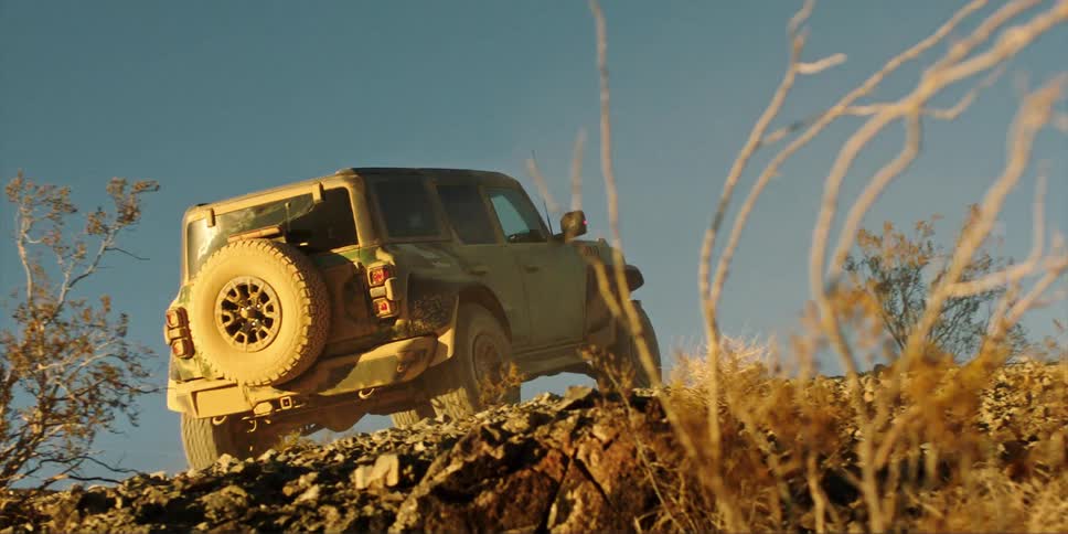 The truck is driving up the hill