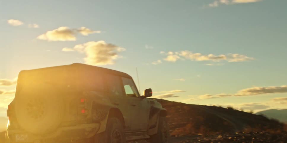 A vehicle is leaving a dust trail while driving off road