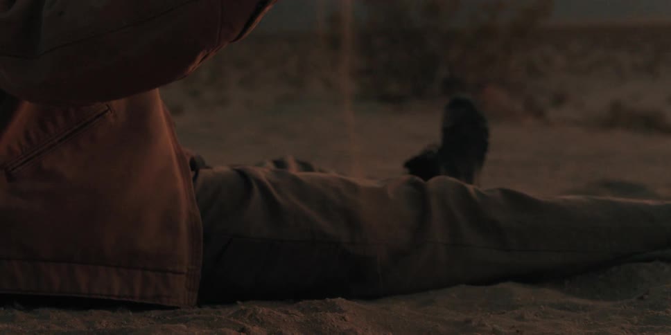 A man drops a handful of sand