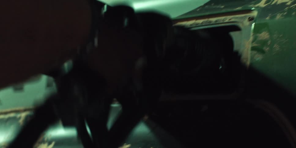 A person angrily pulls a gas pump out of a car