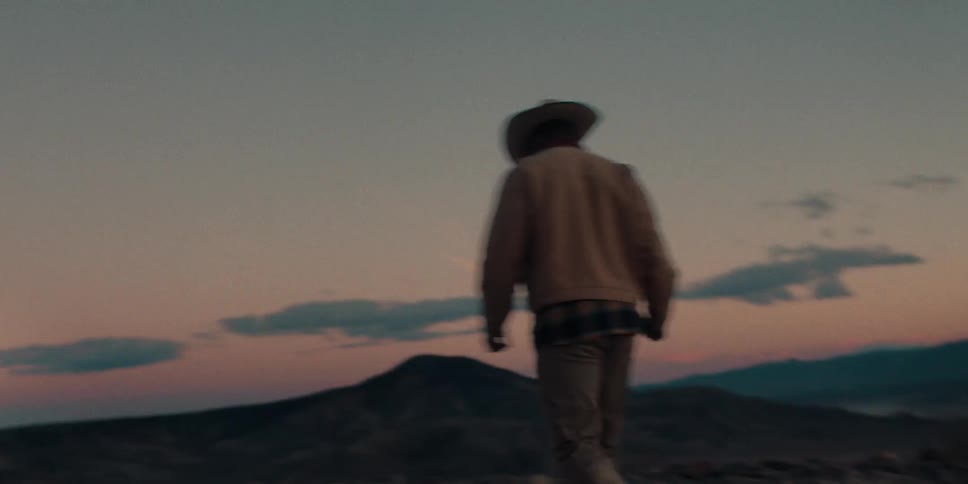 A man walks over to his vehicle in the desert