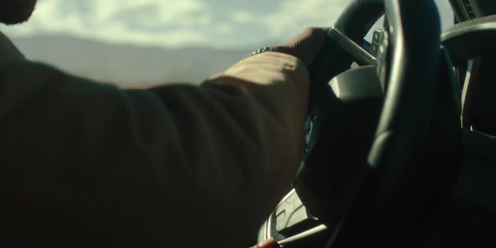 A man is driving in the desert
