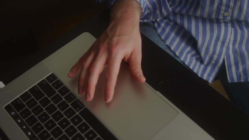A man is using a laptop and a keyboard at the same time