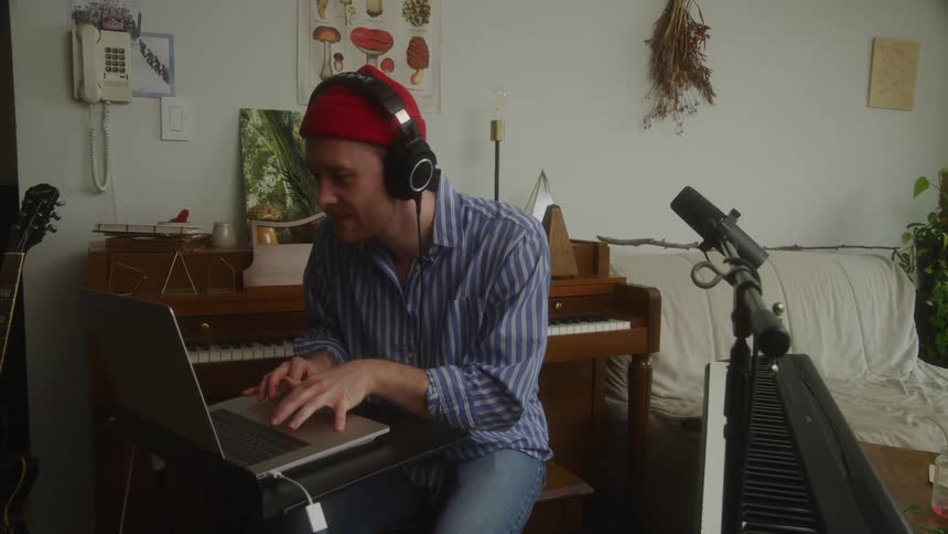 A man is using playing music at home