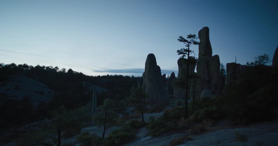 The sun is rising on the desert
