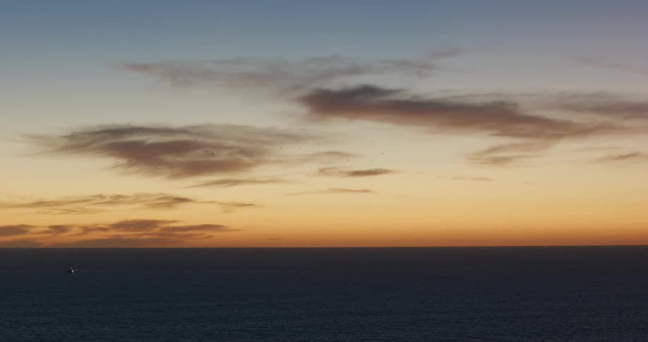 Sunlight glowing in the sky above the ocean water