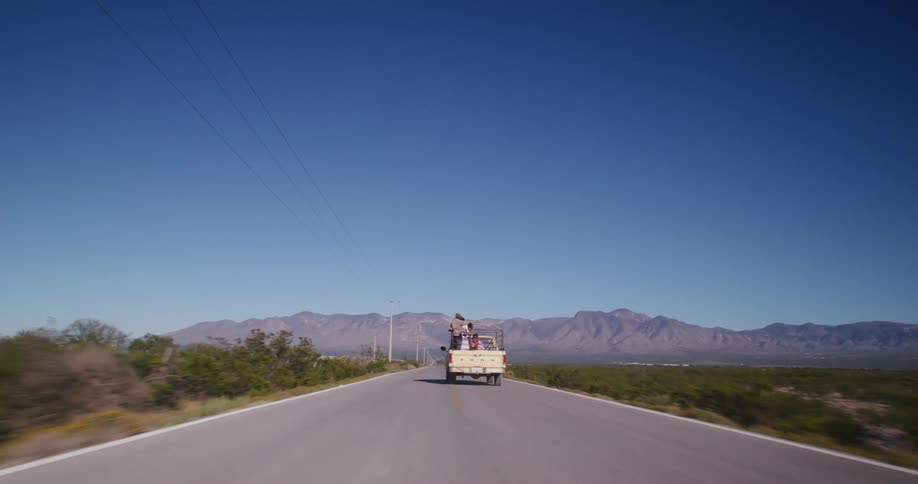 Truck is driving on a road through a rural city