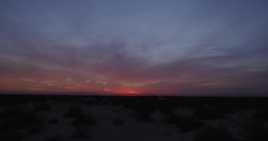 Natural landscape of a field and the red sky on the horizon at dawn