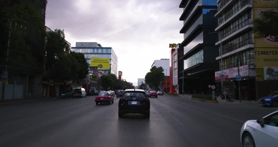 Traffic moves down a road in a city