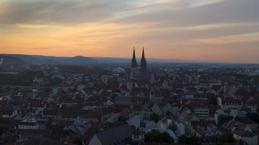 Church spires tower over a city and suburban rea