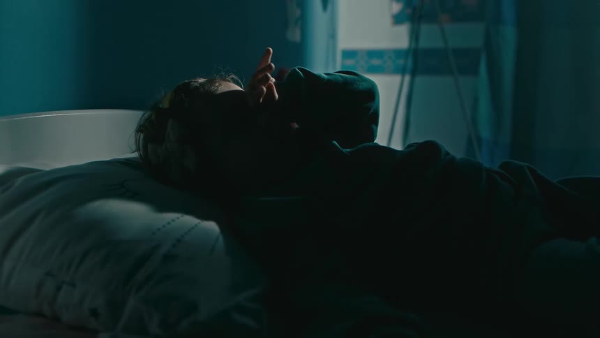Father putting his daughter to bed in the bedroom at night