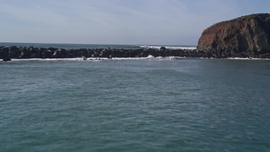 Aerial view of the ocean and coastal shoreline of an island
