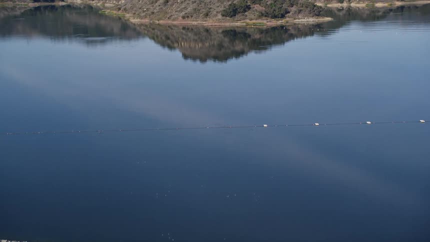 A lake near a mountainous coast