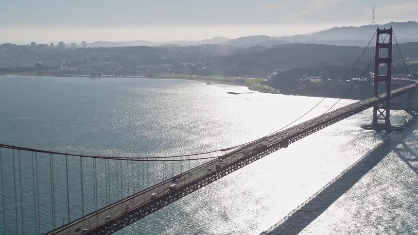 Aerial panorama of the golden gate bridge with vehicle traffic on a blue sky day