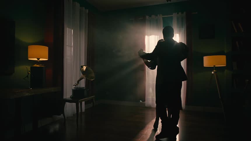 Two people are dancing in the dark room