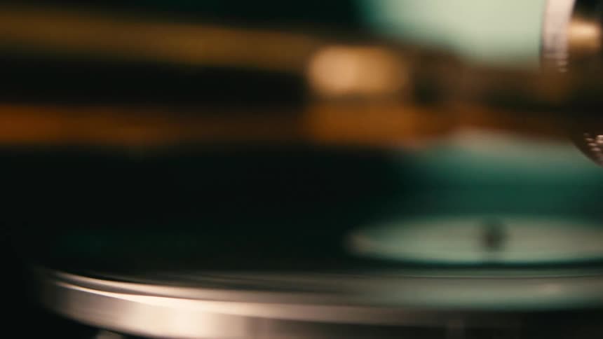 Two people dance while a record plays on a phonograph