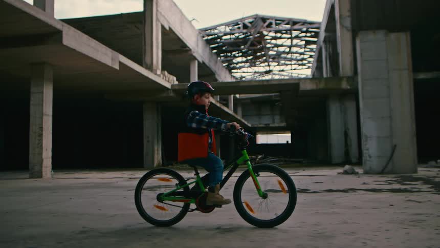 Little boy in helmet riding a bicycle