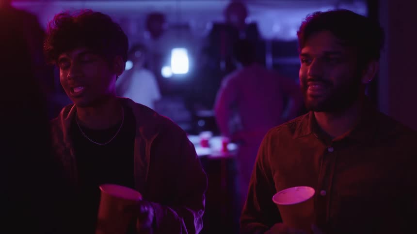 Two indian guys talk up a girl at a club