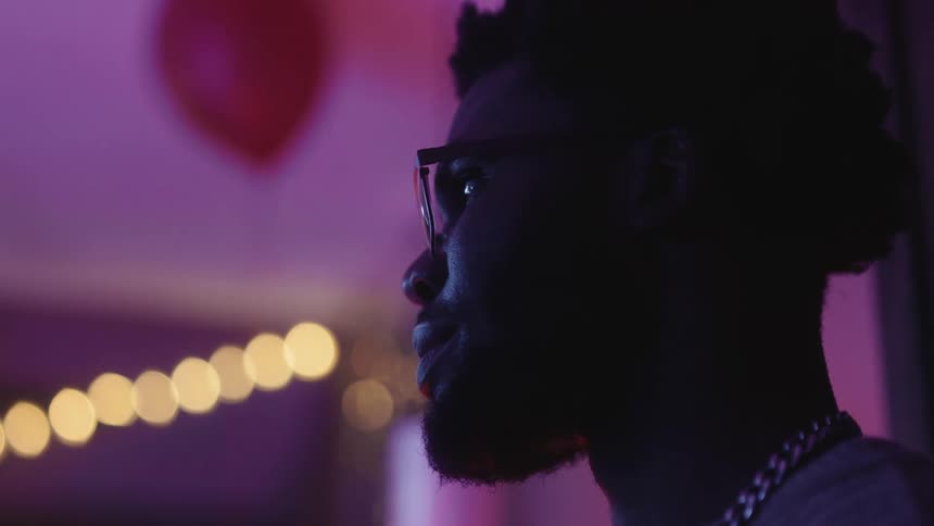 A black man looks around a room