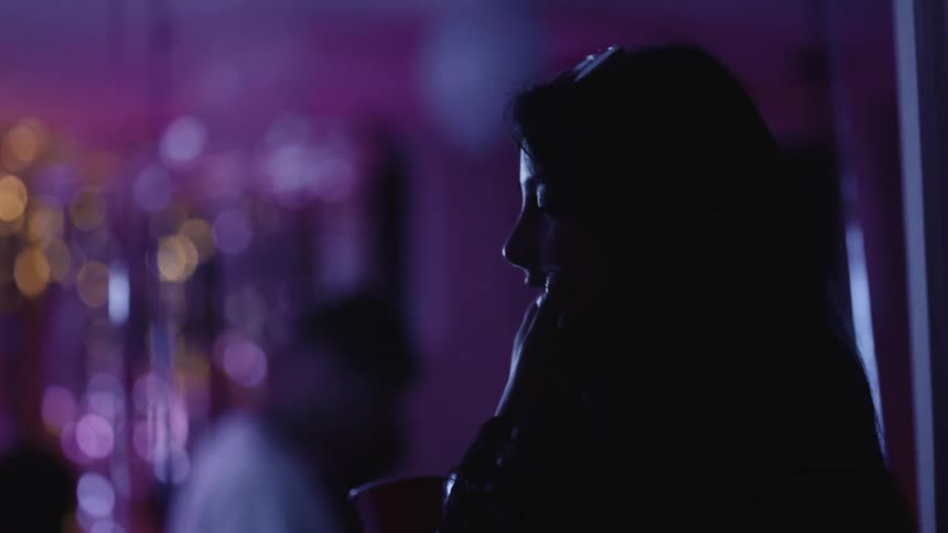 A man and woman are talking at a party
