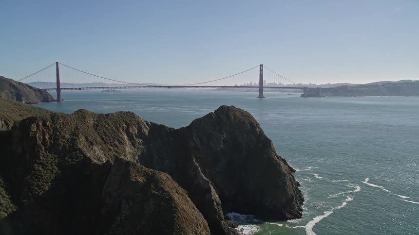 Mountains hide a bridge near a city