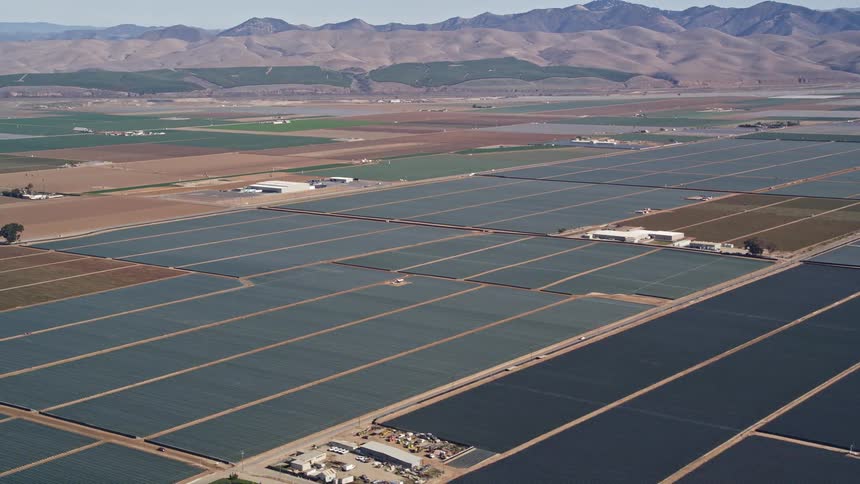 Aerial panorama of agricultural centers and mountains on the horizon