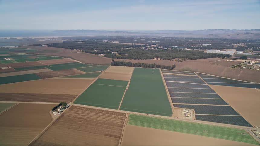 Aerial panorama of a greenish and brown agriculture soil
