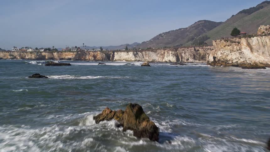 Scenery of a peninsula with rocks in the middle of the sea and mountains around