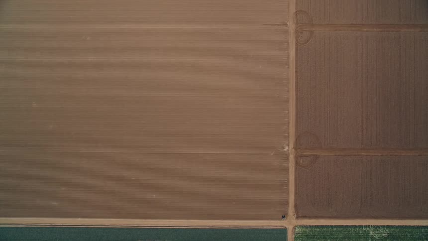 Drone going across farmland and a mixed residential community