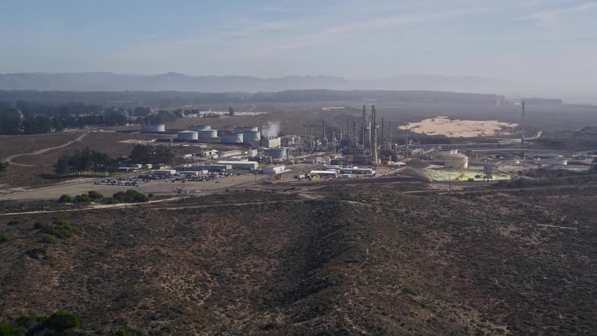 A large power generation facility sits near a desert