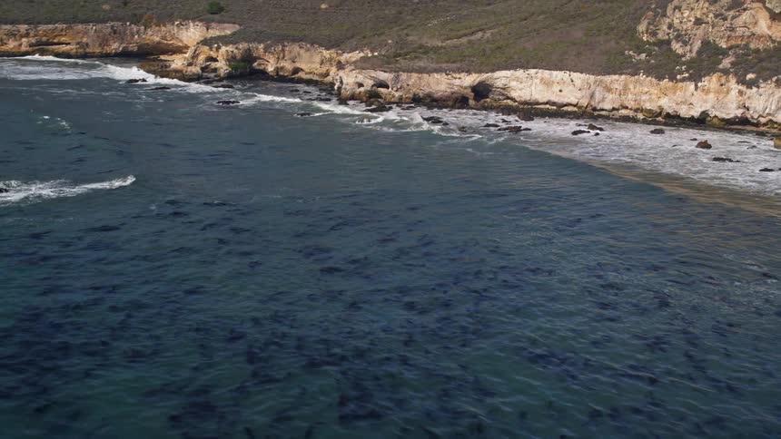 Aerial scenery of the sea surrounded by mountains and rocks on a peninsula