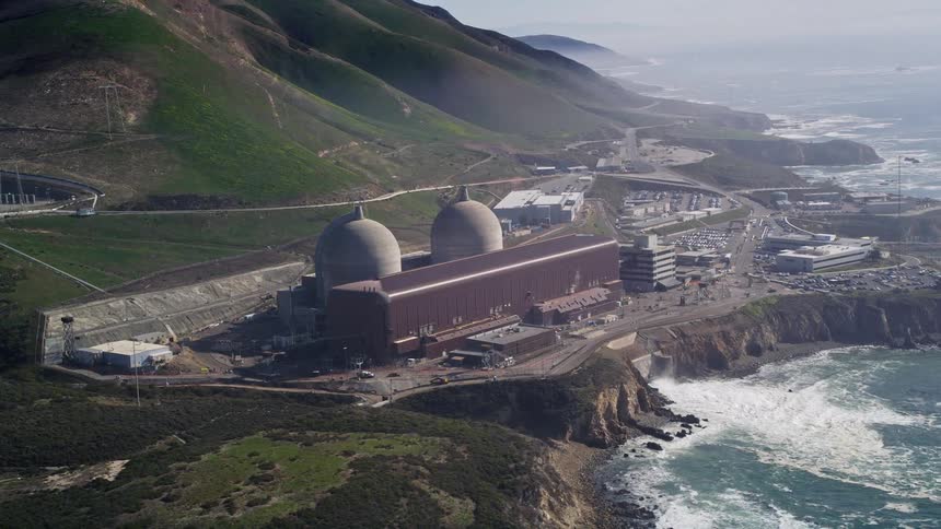 An arial shot of a building that seems to be some sort of utility on a cliff face