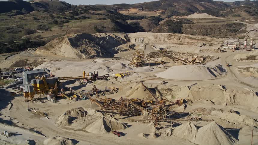 Aerial panorama of extraction machines in rock and mountain areas