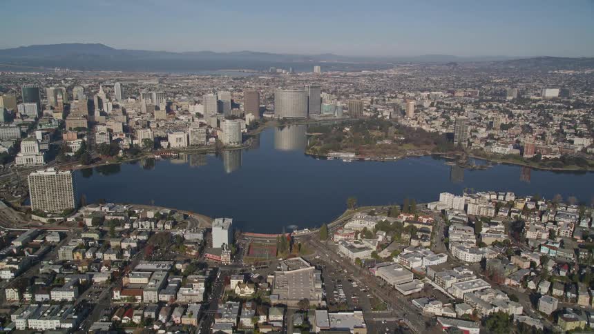 A suburban area gives way to a large body of water by a coastal city