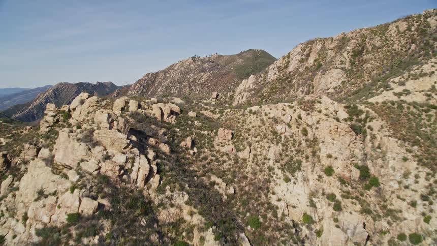 Giant mountains give way to a large coastal city