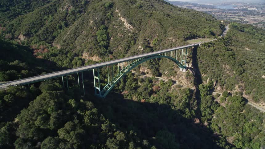 A bridge runs over the mountains
