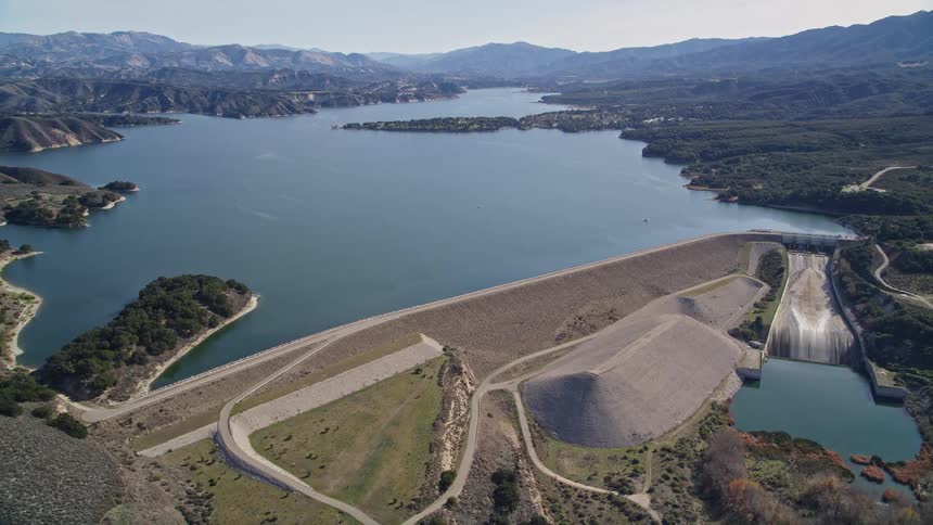 Aerial panorama of a water plant with mountains around it