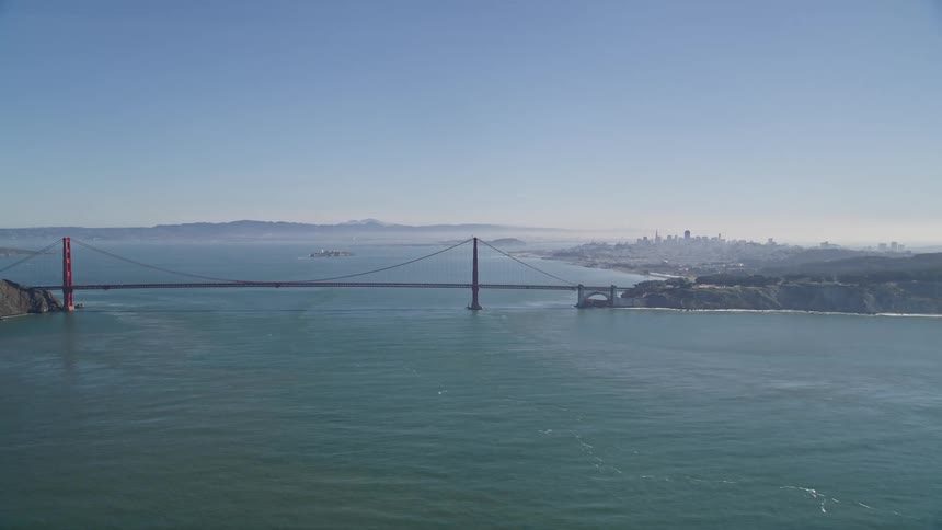 Aerial panorama of the golden gate bridge over the wide blue sea