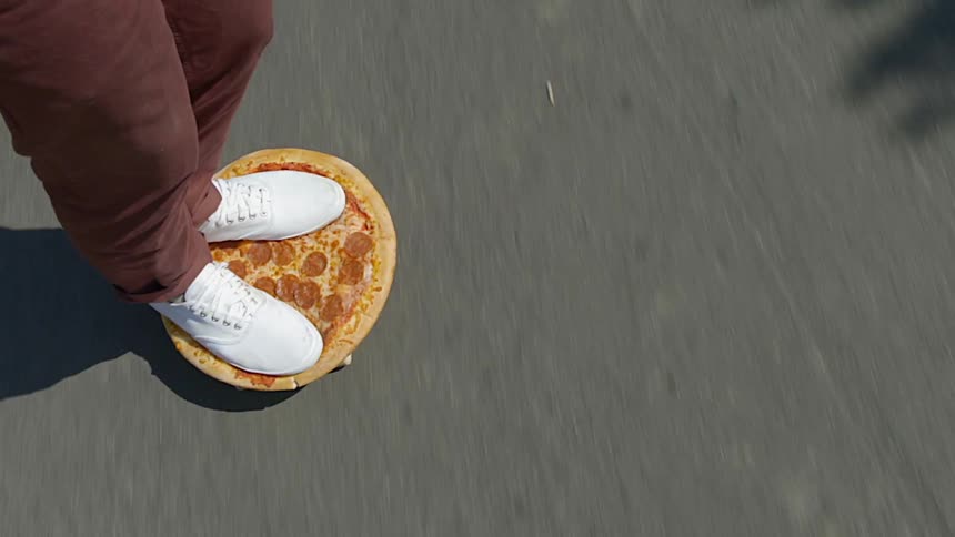 A person skating on a pizza