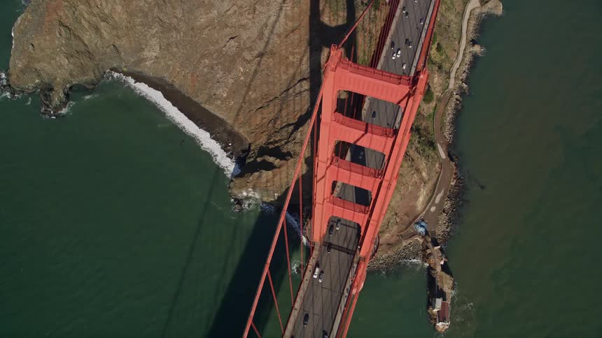 Aerial panorama of a bridge connecting hills with vehicle traffic