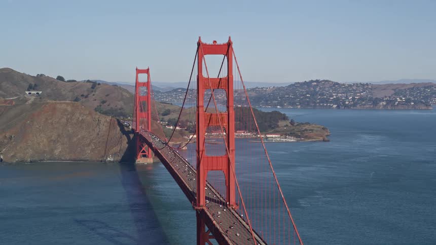 Aerial of commuters commuting across the gold gate bridge during the day
