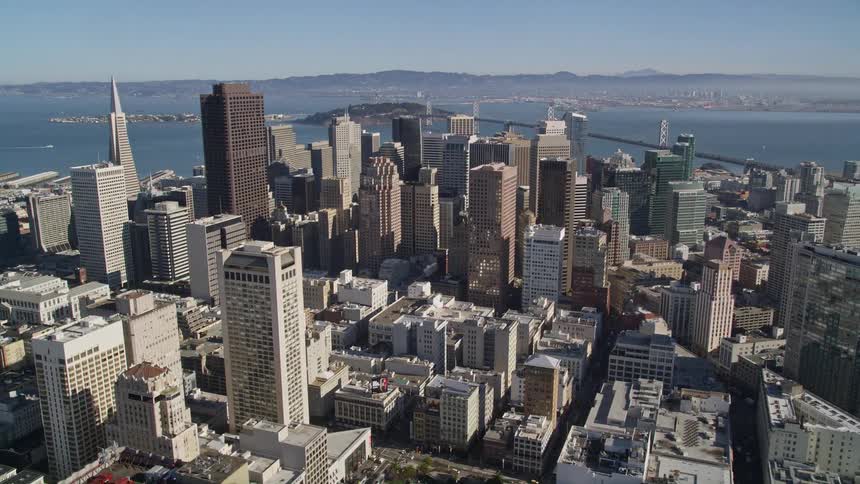 Aerial panorama of a metropolis with residential buildings and commercial skyscrapers by the sea