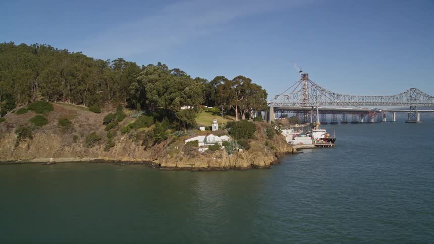 Aerial panorama of a seaside peninsula with a side bridge and a harbor