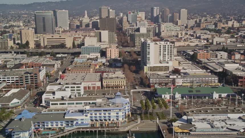 Aerial panorama of a seaside metropolis with mountains on the horizon