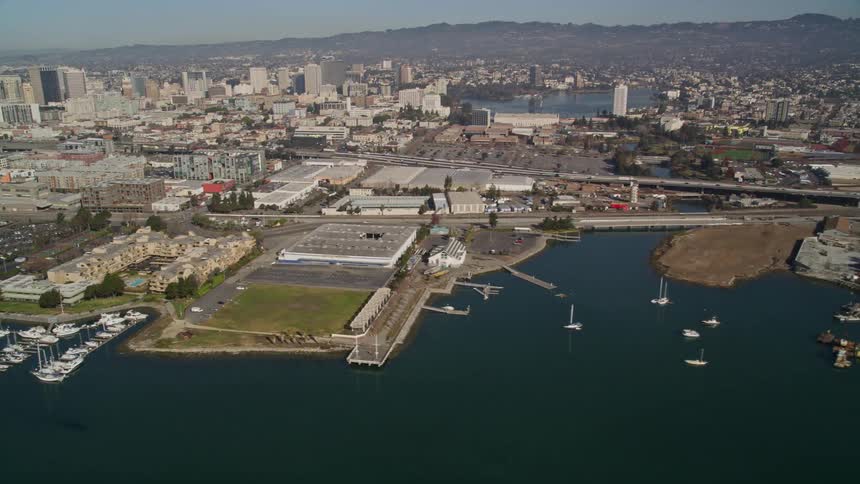 Aerial of a waterway next to a metropolis on a sunny day