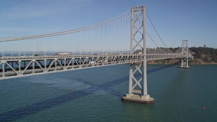 Aerial panorama of an extensive bridge connecting the citys islands to vehicle traffic during a blue sky day