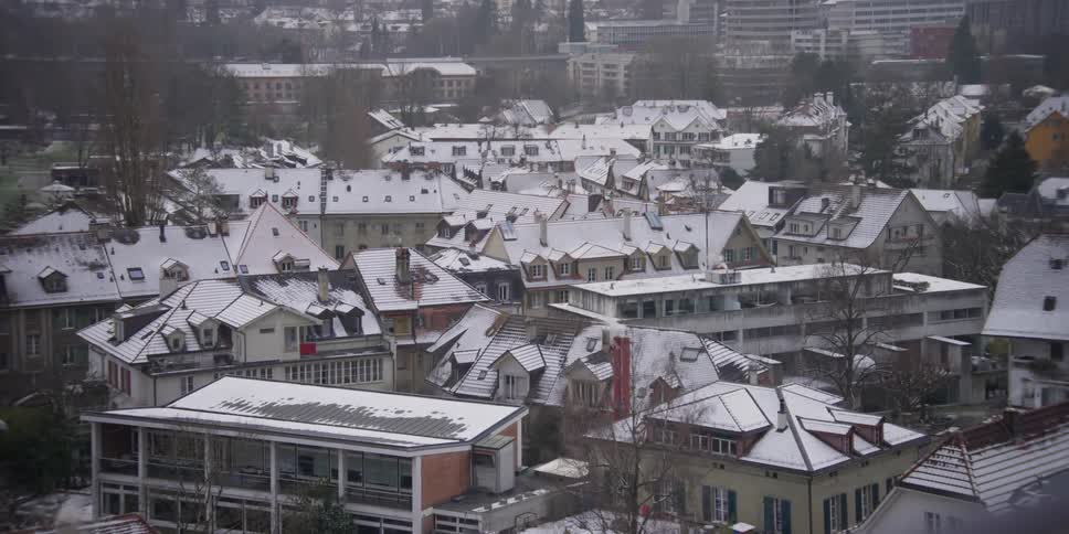 Panorama of a neighborhood in Bern, Switzerland with residential houses and their roofs covered in snow