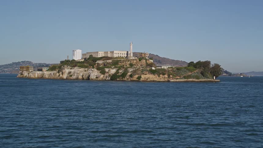 A ferry passes next to alcatraz island in san francisco