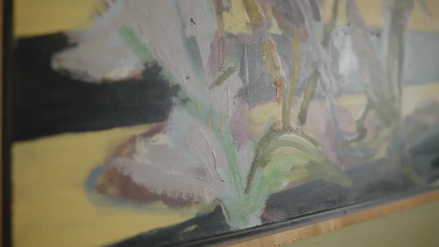 Closeup of an abstract and artistic painting with sunlight reflection