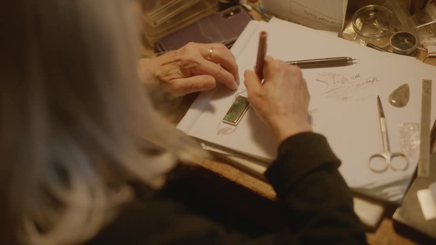 Woman hands preparing a necklace pendant manually